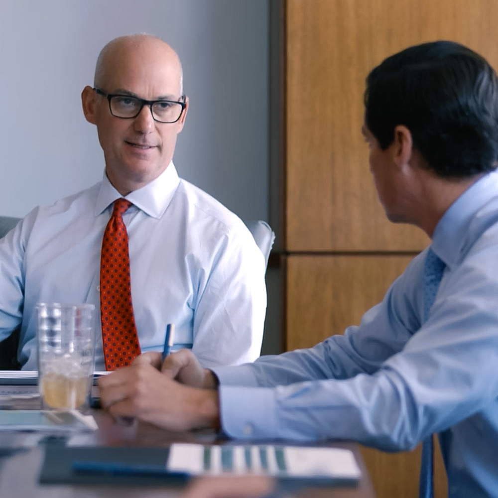 Two BCP employees talking in the conference room.