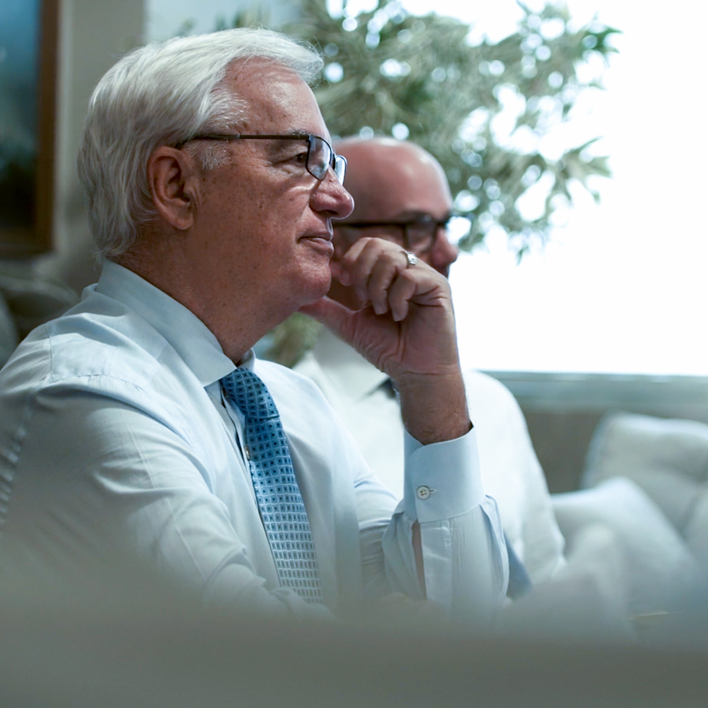 Two BCP employee focused on the speaker during a meeting in the conference.