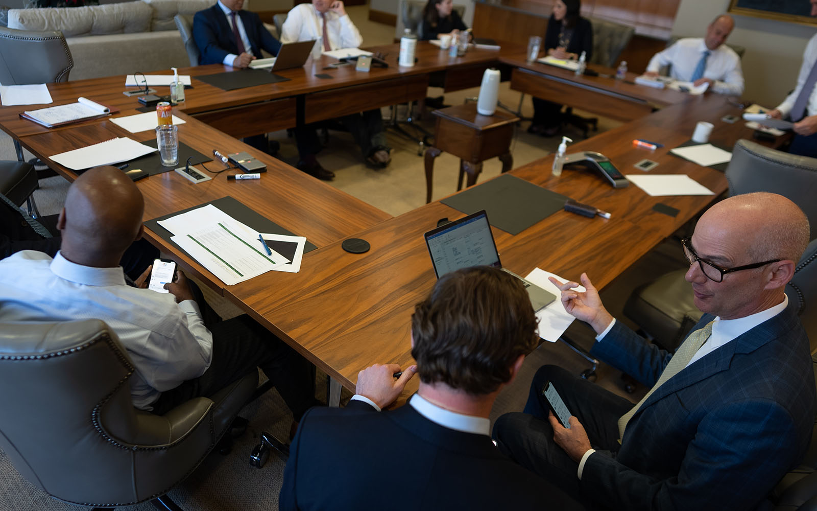 BCP employees chatting around a rectangular conference table.