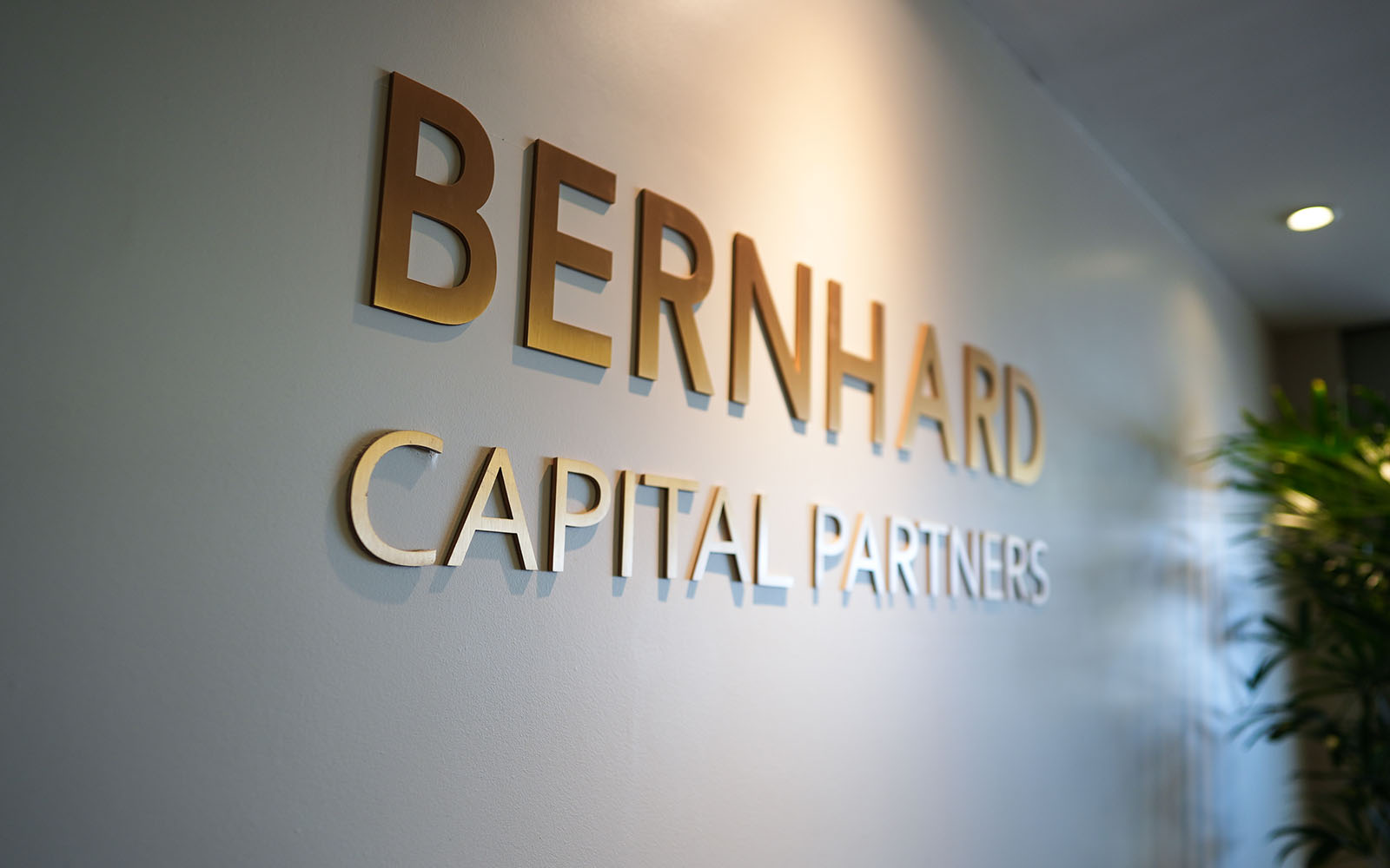 Bernhard Capital Partners Logo on the wall of the entrance of the building.