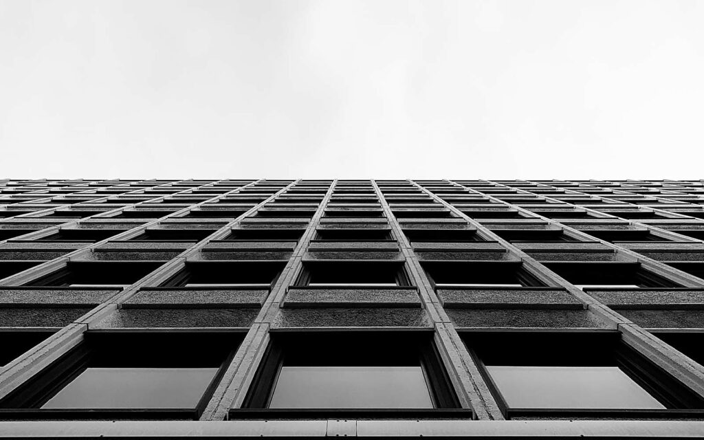 Black and white upward shot of building windows.